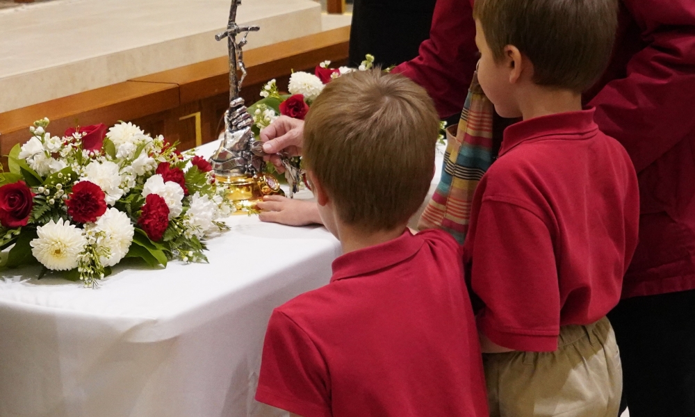 Children venerating a relic of St. John Paul II
