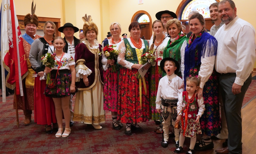 A group of parishioners in traditional Polish clothing